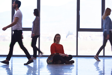 Image showing student girl standing with laptop, people group passing by