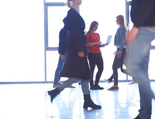 Image showing student girl standing with laptop, people group passing by