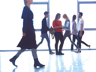 Image showing student girl standing with laptop, people group passing by