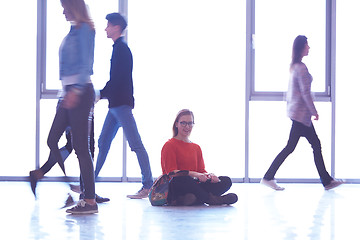 Image showing student girl standing with laptop, people group passing by