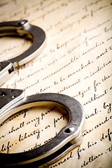 Image showing handcuffs on constitution