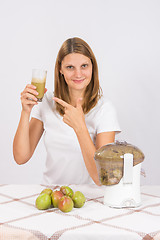 Image showing She points to a glass of fresh juice