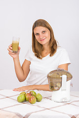 Image showing Woman offers freshly squeezed pear juice