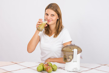 Image showing She lifted it to his lips a glass of pear juice