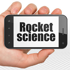 Image showing Science concept: Hand Holding Smartphone with Rocket Science on display