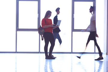 Image showing student girl standing with laptop, people group passing by