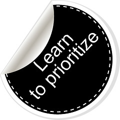 Image showing Learn to prioritize. Inspirational motivational quote. Simple trendy design. Black and white stickers.