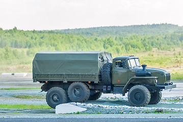 Image showing URAL-4320 curtain sided truck comes around on high obstacle