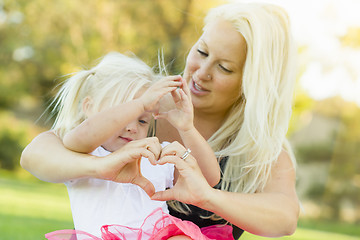 Image showing Little Girl With Mother Making Heart Shape with Hands