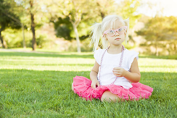 Image showing Little Girl Playing Dress Up With Pink Glasses and Necklace