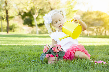 Image showing Little Girl Playing Gardener with Her Tools and Flower Pot