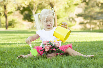 Image showing Little Girl Playing Gardener with Her Tools and Flower Pot