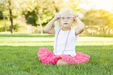 Image showing Little Girl Playing Dress Up With Pink Glasses and Necklace
