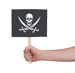 Image showing Hand holding small card - Flag of Pirate