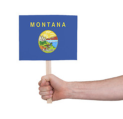 Image showing Hand holding small card - Flag of Montana