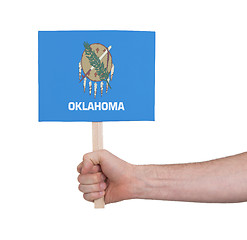 Image showing Hand holding small card - Flag of Oklahoma