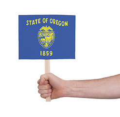 Image showing Hand holding small card - Flag of Oregon