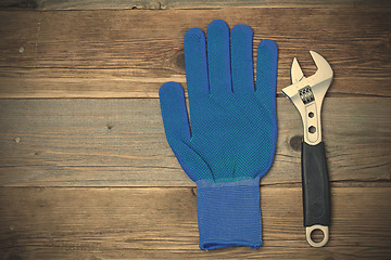 Image showing Blue construction glove and wrench
