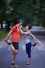 Image showing jogging couple stretching