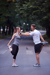 Image showing jogging couple stretching