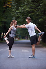 Image showing jogging couple stretching