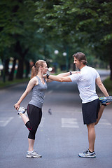 Image showing jogging couple stretching