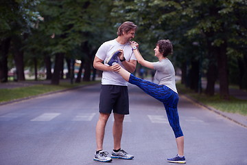 Image showing jogging couple stretching