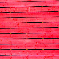 Image showing red wall in old construction nail and house