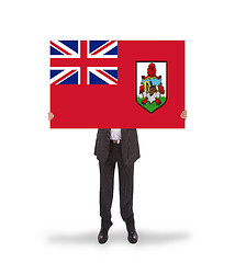 Image showing Smiling businessman holding a big card, flag of Bermuda