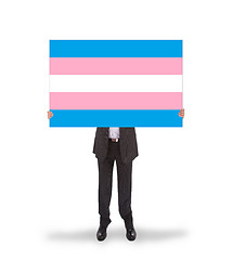 Image showing Smiling businessman holding a big card, flag of Trans Pride