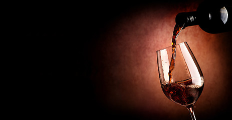 Image showing Pouring wine on brown