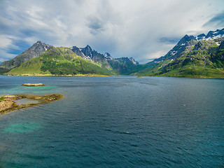 Image showing Mountain peaks around fjord