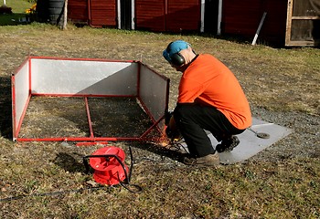 Image showing Man grinding steel