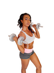 Image showing Young lady exercising with dumbbell\'s.