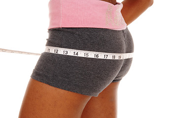 Image showing Girl measuring her butt, body part.