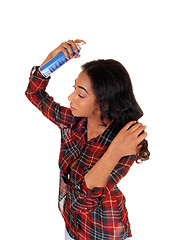 Image showing African american woman using hair spray.