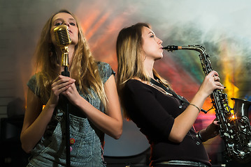 Image showing Young pretty women with saxophone