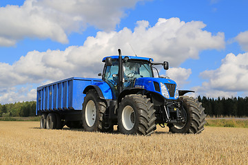 Image showing New Holland T7.250 Tractor and Agricultural Trailer on Field