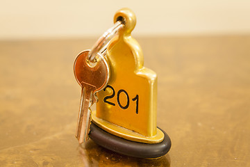 Image showing Hotel Room Key lying on Bed with keyring