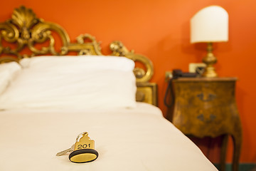 Image showing Hotel Room Key lying on Bed with keyring