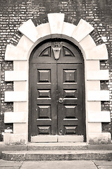 Image showing wooden parliament in london old church door and marble antique  