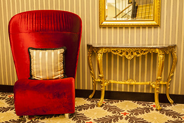 Image showing Royal Armchair in red in warm athmosphere decoration