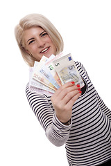 Image showing Smiling woman holding a handful of Euro notes