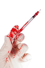 Image showing Bloody gloved hand holding a syringe