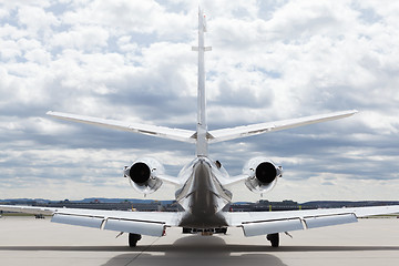 Image showing Aircraft learjet Plane in front of the Airport with cloudy sky