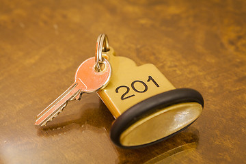 Image showing Hotel Room Key lying on Bed with keyring