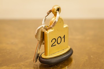 Image showing Hotel Room Key lying on Bed with keyring