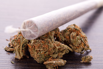 Image showing Close up of dried marijuana leaves and joint