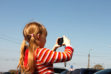 Image showing Little girl photographed the urban scene