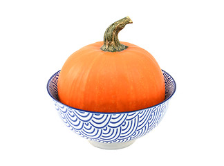 Image showing Bright orange sugar pumpkin in a blue and white bowl